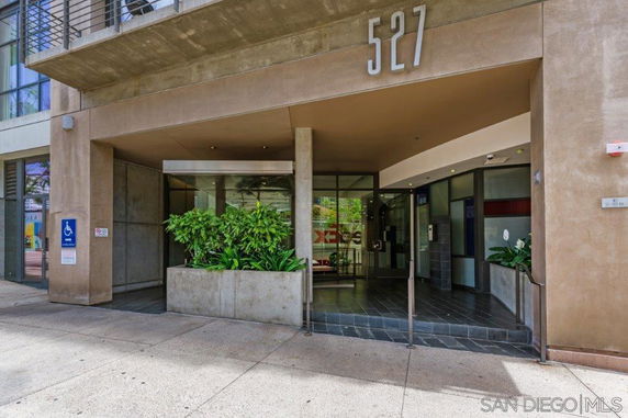 Entrance view of a building with glass doors and signage displaying the number 527.