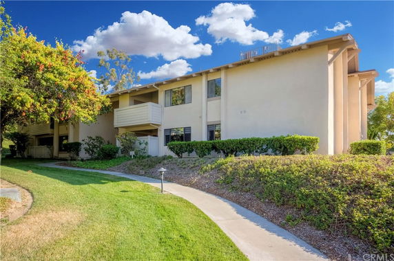 Front view of a two-story residential building with balconies.