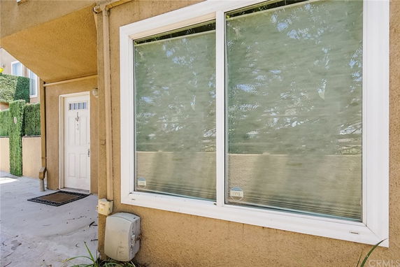Close-up view of a residential building's entrance with a door and large windows.
