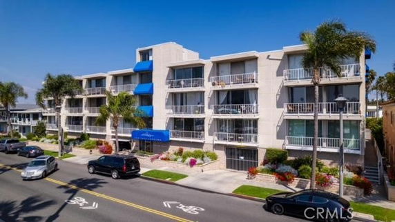 Front view of a multi-story apartment building with balconies.