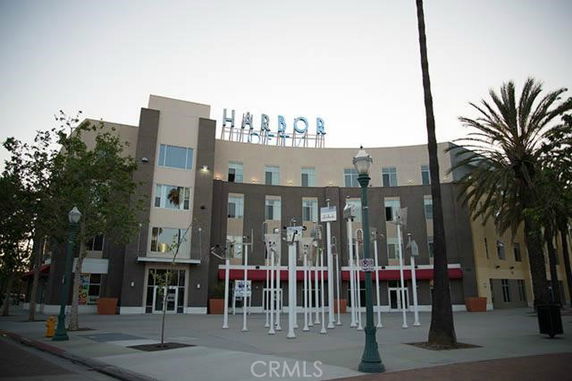 Front view of a multi-story building with prominent signage on the roof.