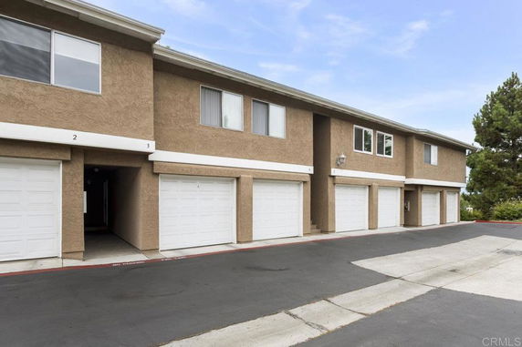 Front view of a multi-story building with multiple garage doors.