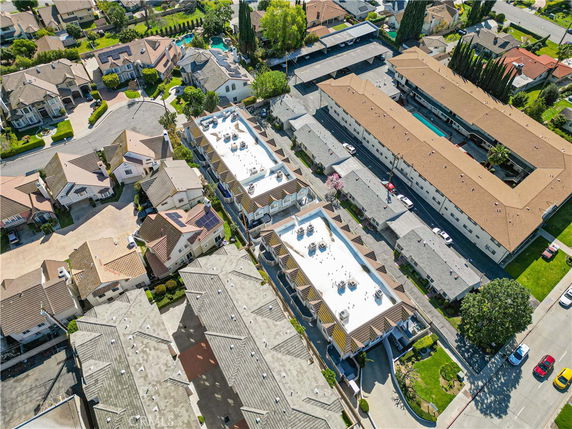 Aerial view of residential neighborhood with houses and apartment buildings.
