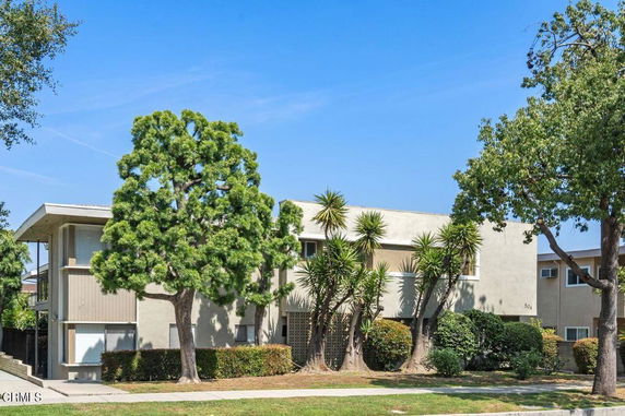Front view of a two-story building with a flat roof and minimalist design.