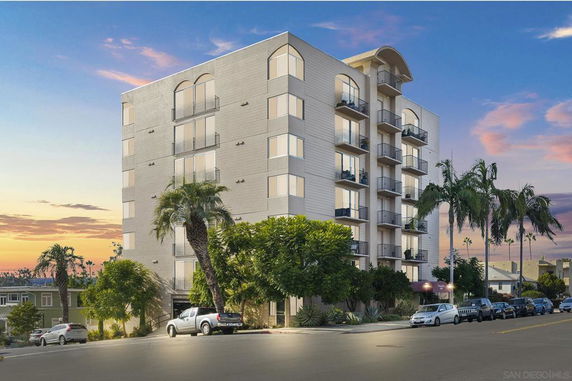 Front view of a multi-story apartment building with balconies.