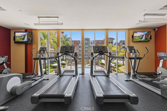 Gym area with treadmills and exercise equipment in a recreation space.