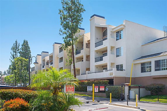 Front view of a multi-story apartment building with balconies.