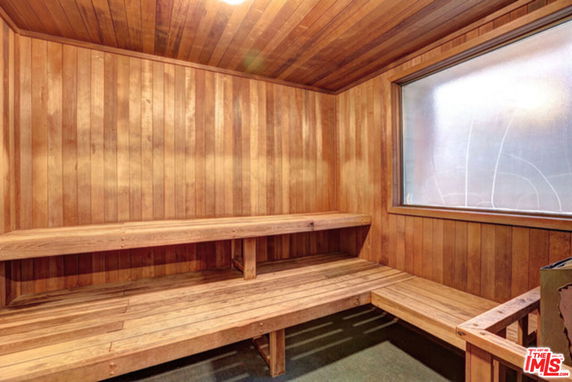 Interior view of a wooden sauna room with benches.