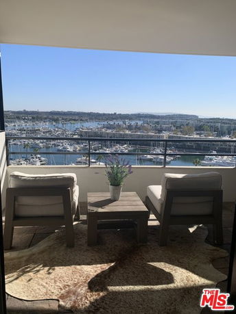Panoramic view from a balcony overlooking a marina with boats.