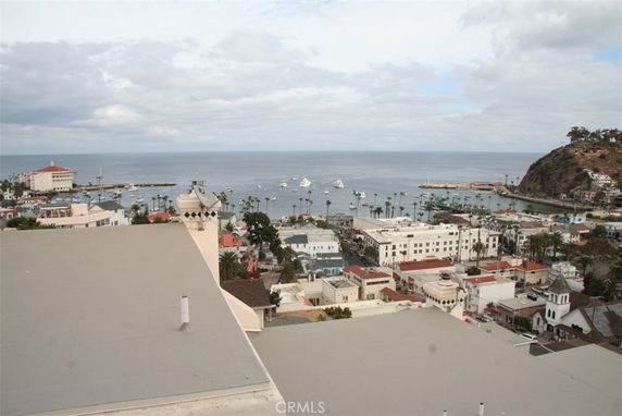 Panoramic view from a building overlooking a coastal town and ocean.