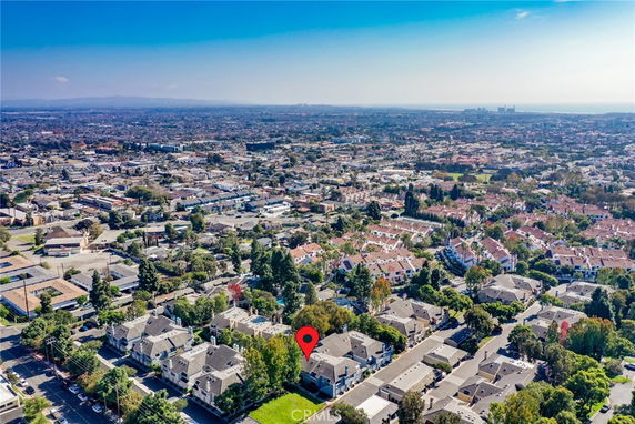 Panoramic aerial view of a suburban area with multiple residential houses and buildings.