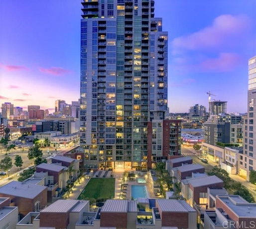 Front view of a tall residential building in an urban environment.
