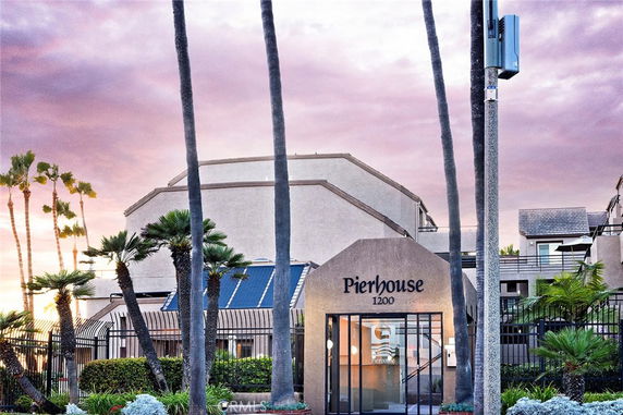 Front view of a building named Pierhouse with a modern facade and a gated entrance.