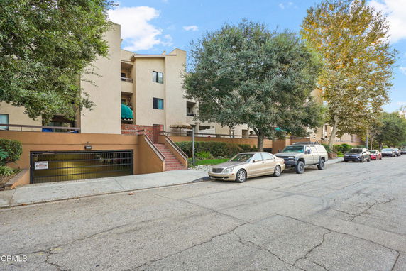 Front view of a multi-story residential building with balconies.