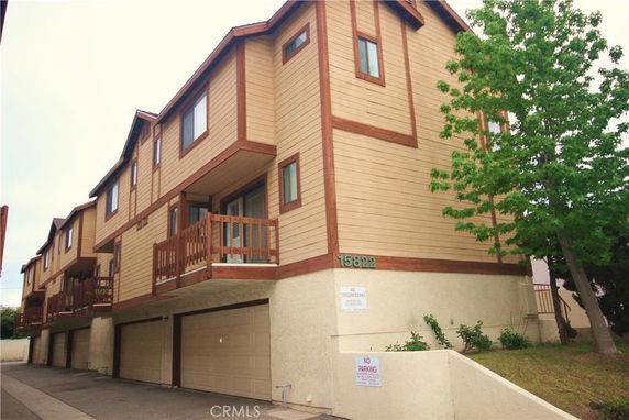 Front view of a multi-story building with attached garages.