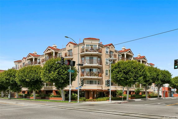 Front view of a multi-story residential building at a street corner.