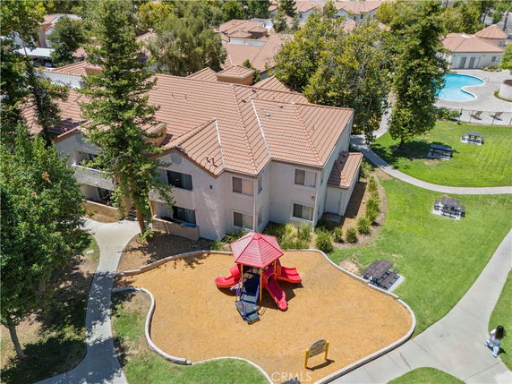 Aerial view of a two-story building with a red-tiled roof.