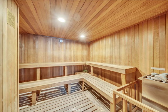 Interior of a wooden sauna with benches and a heater.