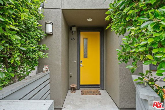 Front entrance view of a house with a yellow door.