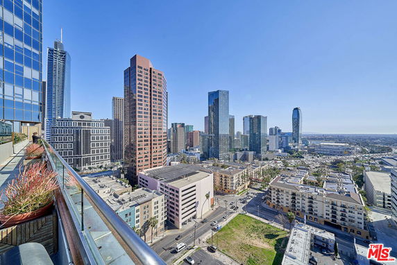 Panoramic view of a city skyline with tall buildings from a high vantage point.