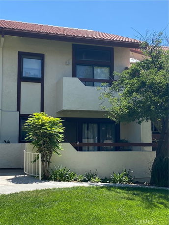 Front view of a two-story house with a balcony.