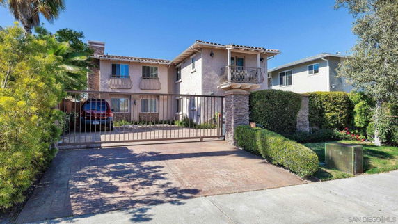 Front view of a two-story house with a gated driveway.