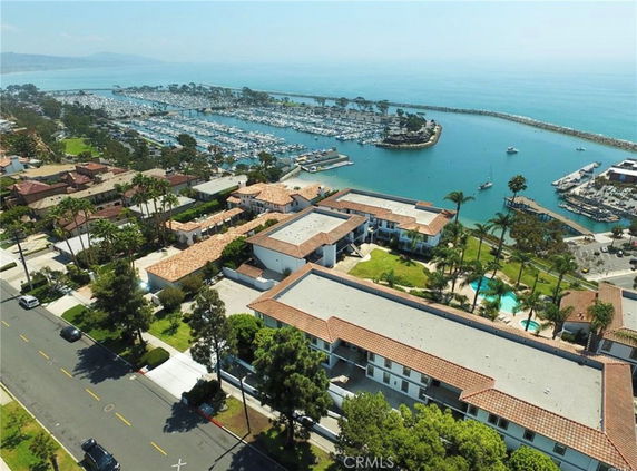 Panoramic view of apartment buildings near a marina with ocean view.