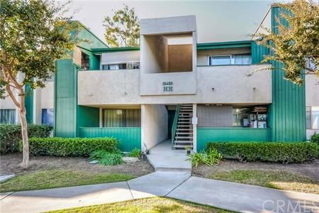Front view of a two-story building with green accents and a central staircase.