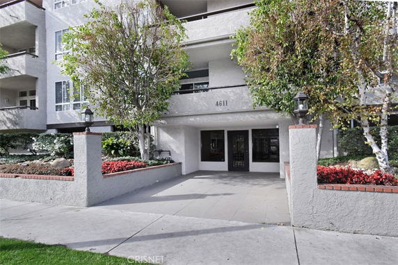 Front view of a multi-story building with landscaped entrance.