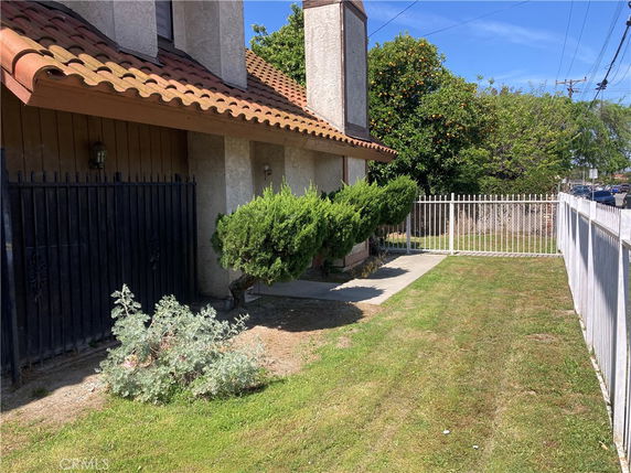 Front view of a house with a tiled roof and chimney.