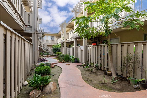 View of a two-story apartment complex with walkways and balconies.