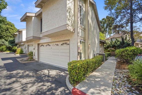 Front view of a townhouse with attached garage.
