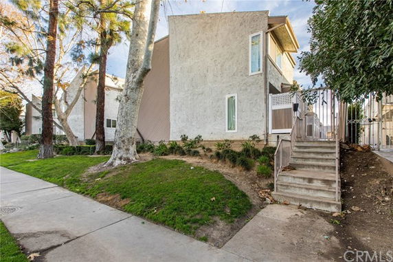 Front view of a two-story residential building with an outdoor staircase.