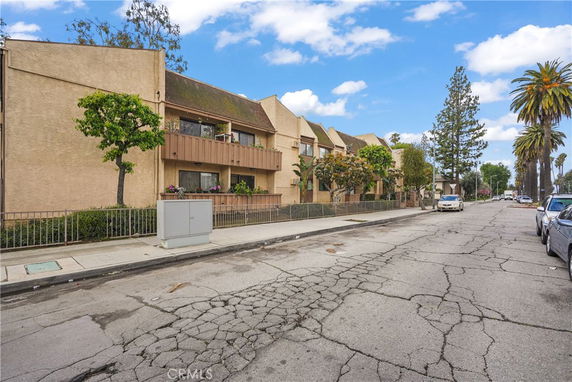 Front view of a residential building with multiple units and balconies.
