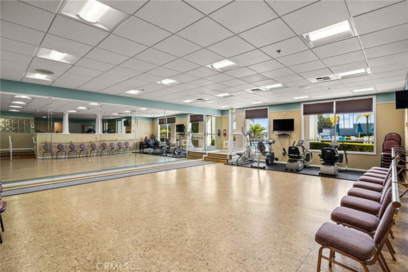 Interior of a clubhouse fitness area with mirrors and exercise equipment.