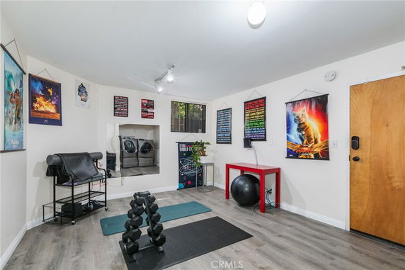 Interior view of a room used for fitness and recreation with exercise equipment and motivational posters.