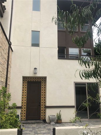 Front view of a multi-story house with a decorated entrance.
