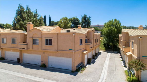 Front view of multi-unit townhouses with garages.