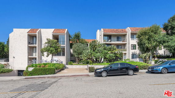 Front view of a multi-story residential building with balconies.