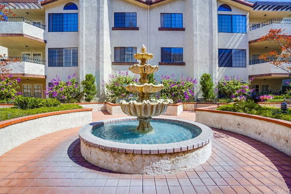Front view of a building with a central water fountain.