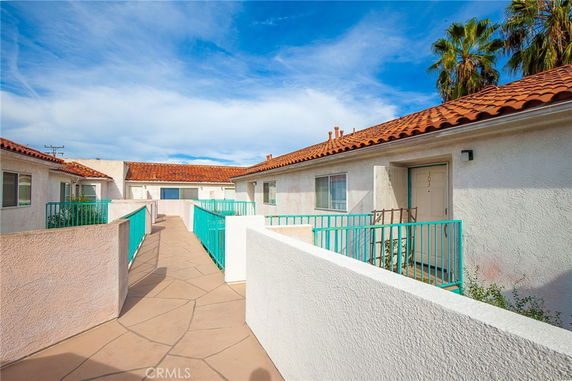 Front view of a building with tiled roof and turquoise railings.