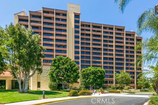 Front view of a multi-story residential building with balconies.