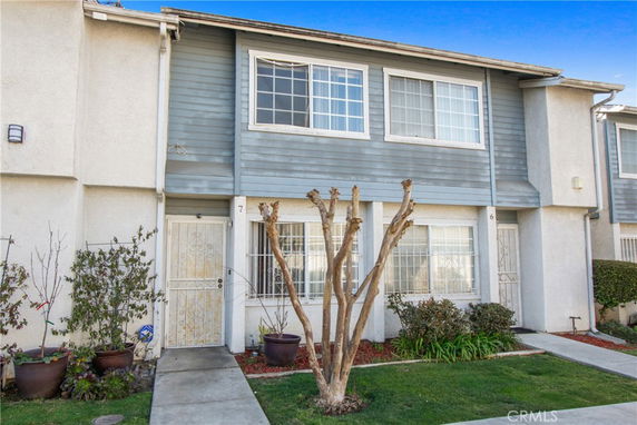 Front view of a two-story townhouse with white and blue exterior.