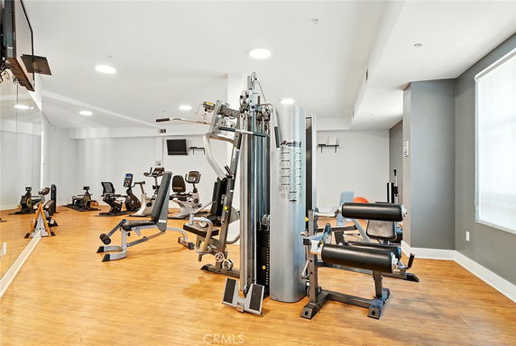 Indoor gym area with exercise equipment and machines.