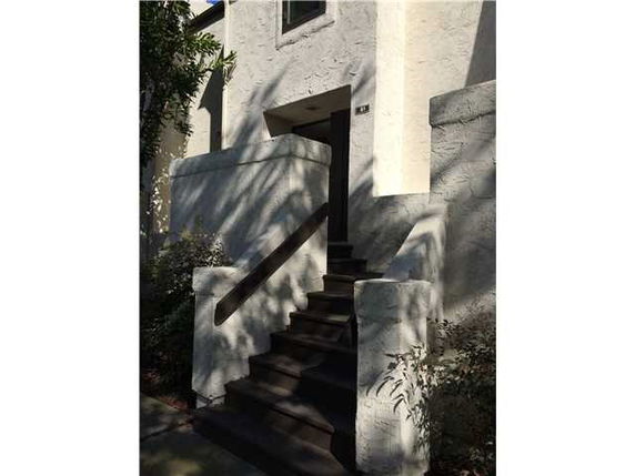 Entrance view of a house with stairs leading to the front door.