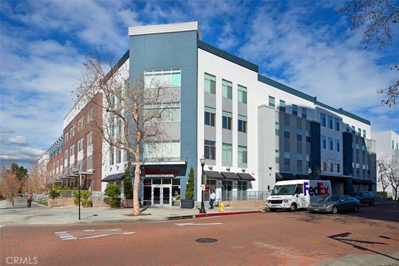 Front view of a multi-story commercial building with a pharmacy on the ground floor.