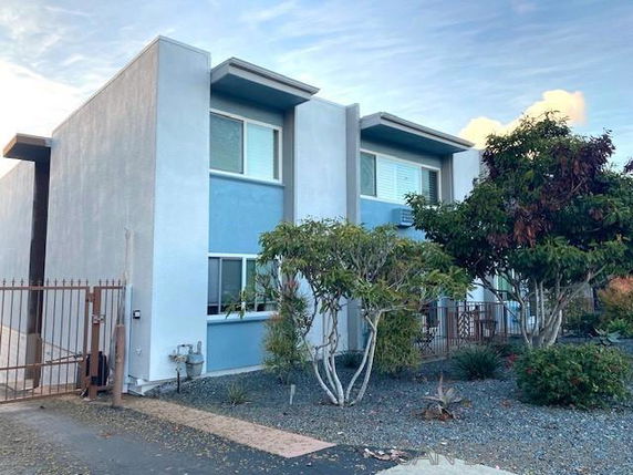 Front view of a modern two-story building with a simple facade.