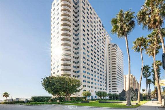 Front view of a high-rise building with multiple balconies.