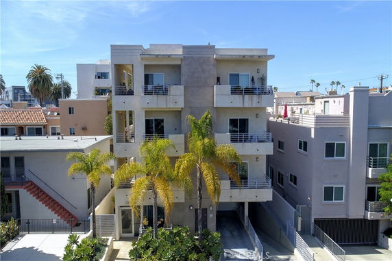 Front view of a multi-story apartment building with balconies.
