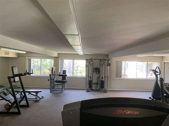 Indoor gym area with fitness equipment.